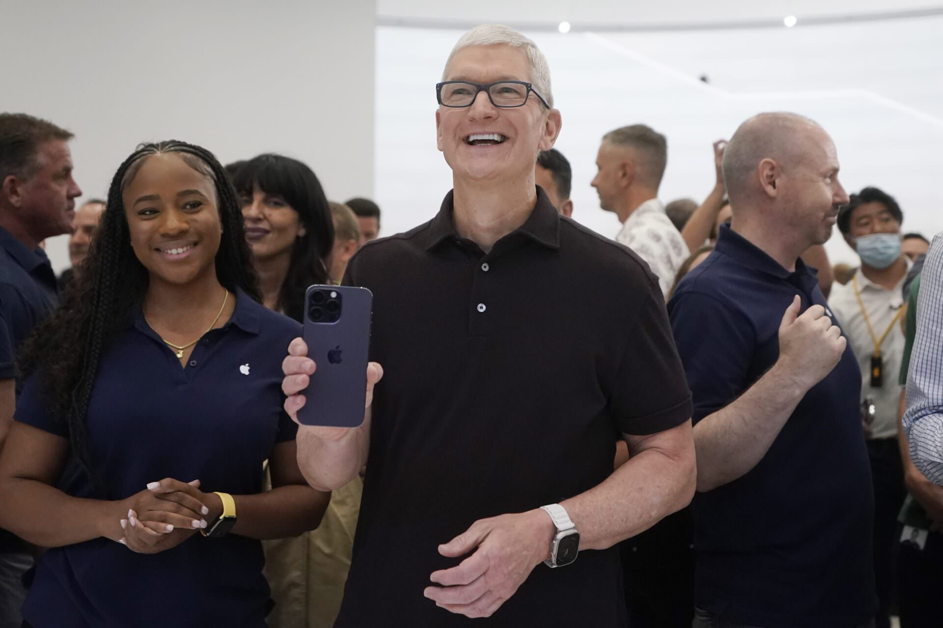 Apple CEO Tim Cook holds a new iPhone model at an Apple event on the campus of Apple's headquarters in Cupertino, Calif., Wednesday, Sept. 7, 2022. (AP Photo/Jeff Chiu)