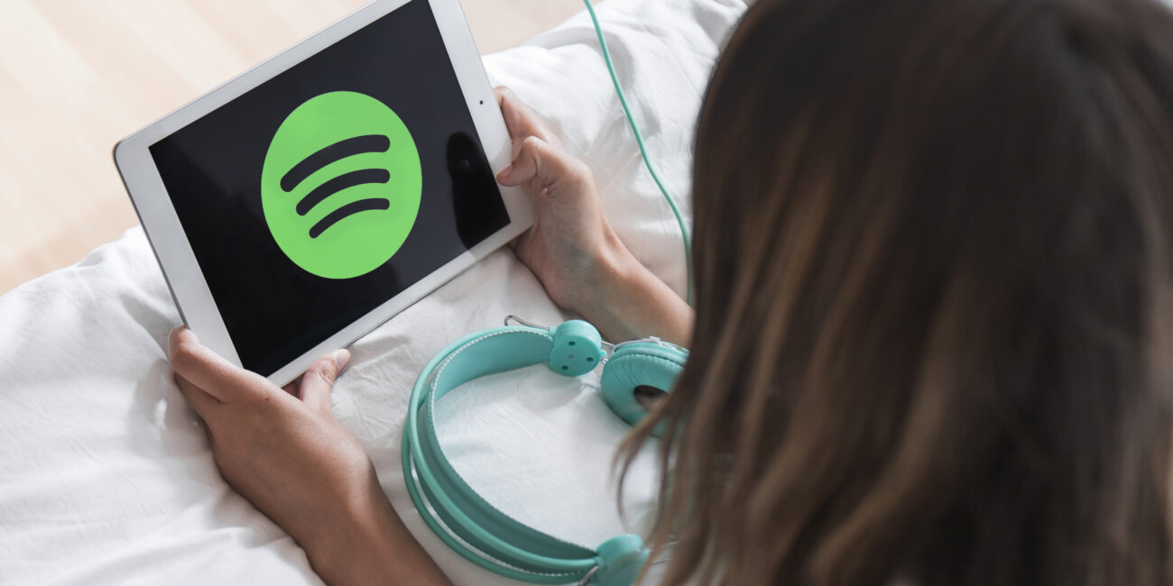 young-woman-holding-tablet-with-spotify-app