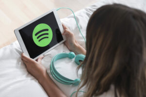 young-woman-holding-tablet-with-spotify-app
