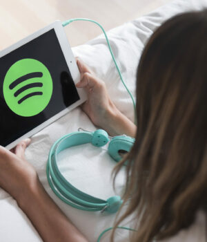 young-woman-holding-tablet-with-spotify-app